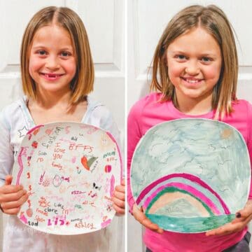 Two girls holding decorated ceramic plates, one covered in colorful doodles and names, the other with a rainbow design, showing DIY Sharpie plates.