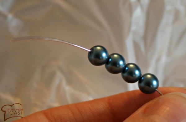 stringing four beads onto wire
