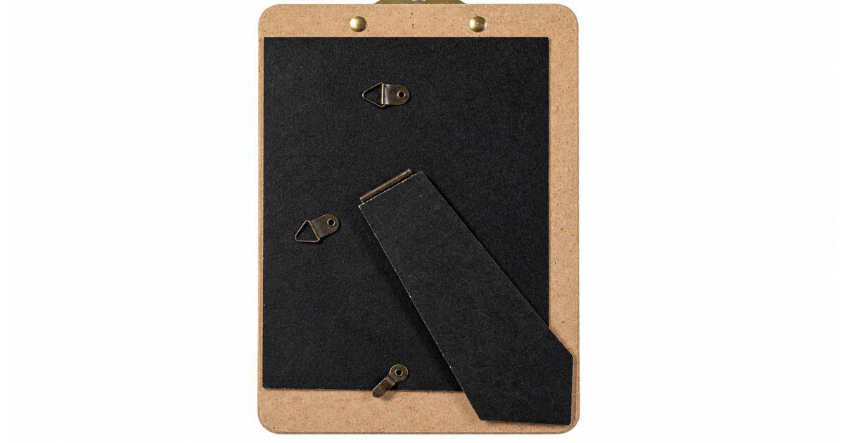 Back of a decorative standing clipboard showing a fold-out easel stand and multiple hanging hardware options for tabletop or wall display.