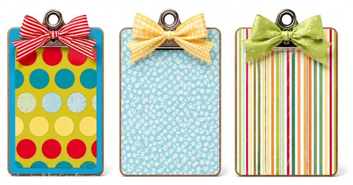 Three decorative standing clipboards with colorful patterned paper and matching ribbon bows, each featuring a different design for gifts or home decor.