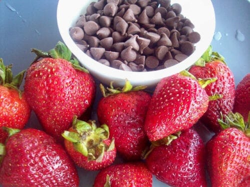 fresh strawberries and chocolate chips in a white bowl