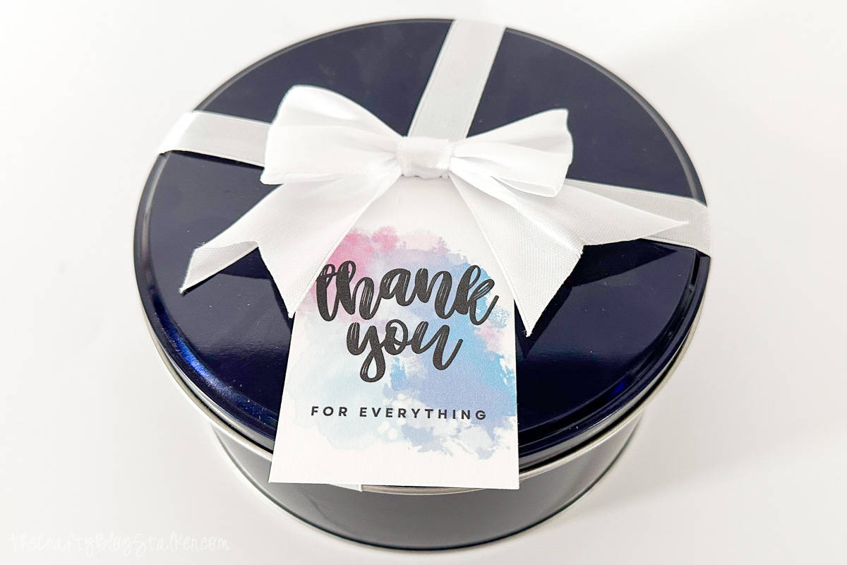 Round blue tin with a thank you tag.