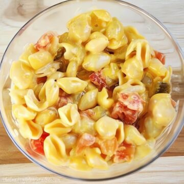 Close-up of a bowl filled with spicy Velveeta shells and cheese, mixed with ROTEL diced tomatoes and green chilies for a bold, creamy.