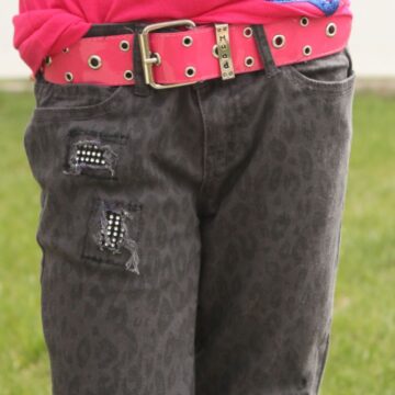 A young girl modeling her bling jeans.