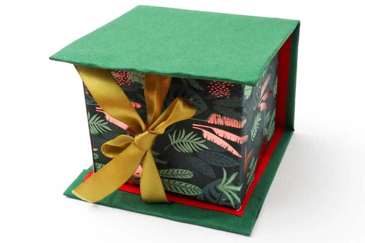 Cardboard gift box with a tied ribbon.