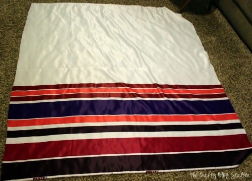 white fabric with purple and pink stripes laid out