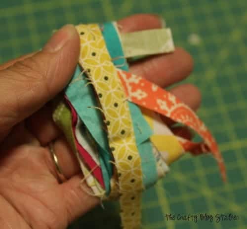 wrapping fabric straps around four fingers