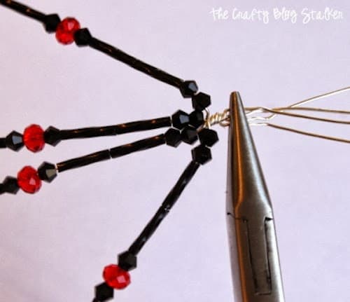 twisting the beaded spider legs together