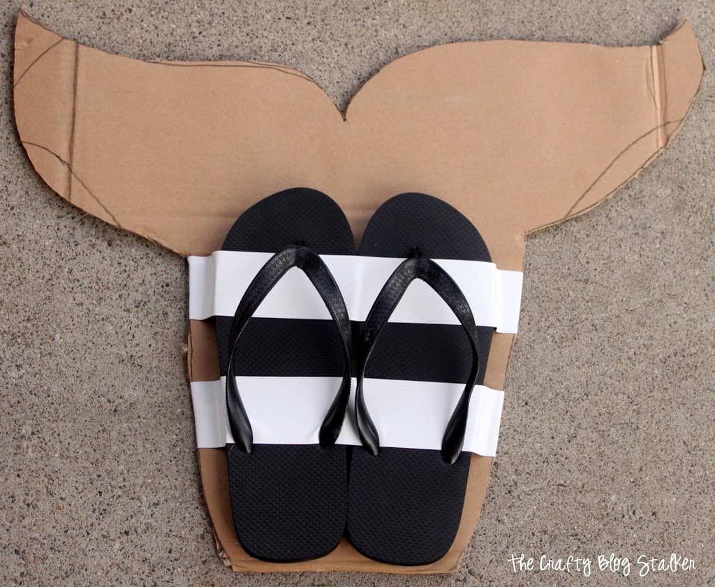 Flip-flops secured to fin cut out with gorilla tape.