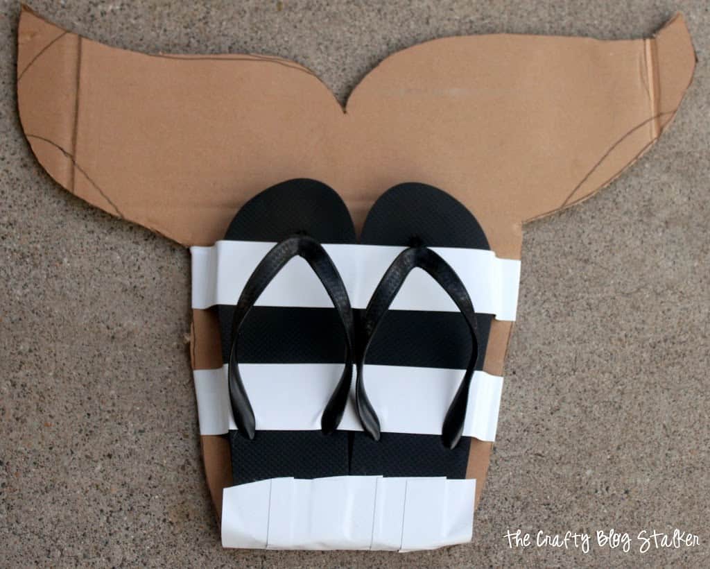 Tape applied to flip-flops to secure the heels of the shoe to the cut out.