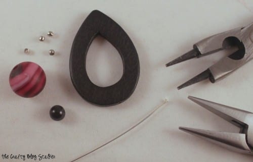 jewelry pliers, head pin, and beads to make earrings