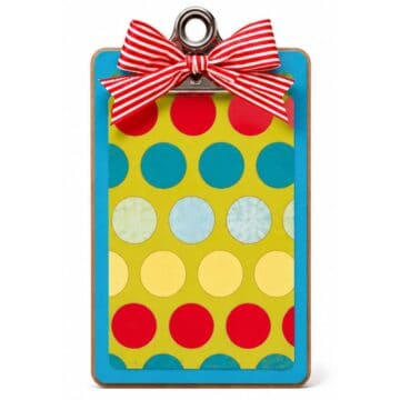 Decorative standing clipboard with a colorful polka dot insert, blue painted border, and a red-and-white striped bow attached at the top.