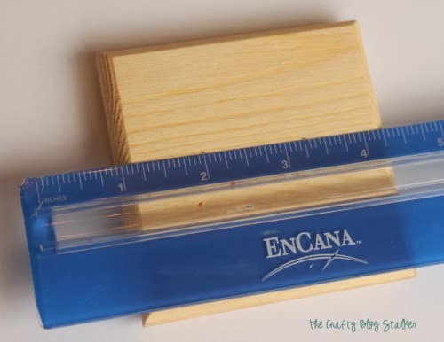 measuring 1 ¼ inch on the lid of the wood box