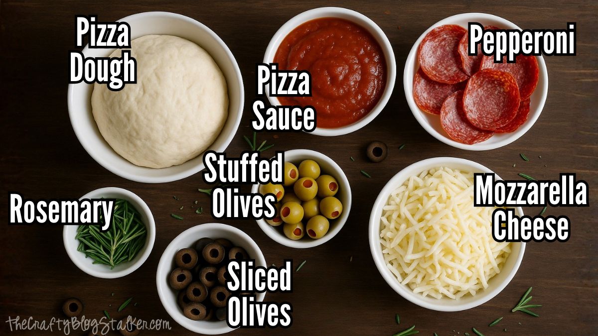 Bowls of pizza ingredients on a wooden table, including dough, sauce, pepperoni, mozzarella cheese, stuffed olives, sliced olives, and rosemary.