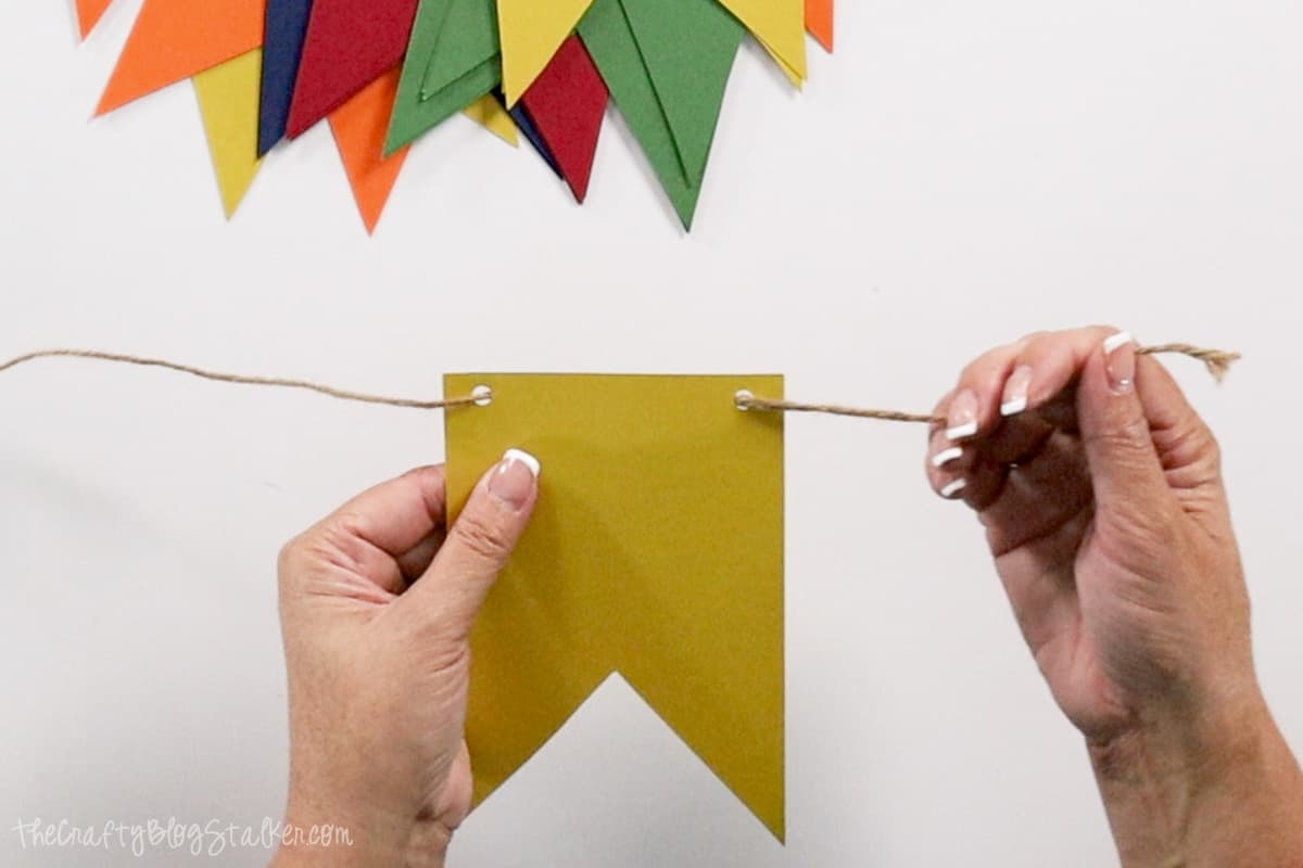 Stringing a flag to create a banner.
