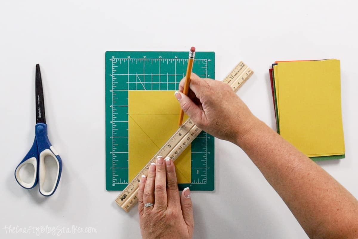 Drawing an X on the piece of paper.