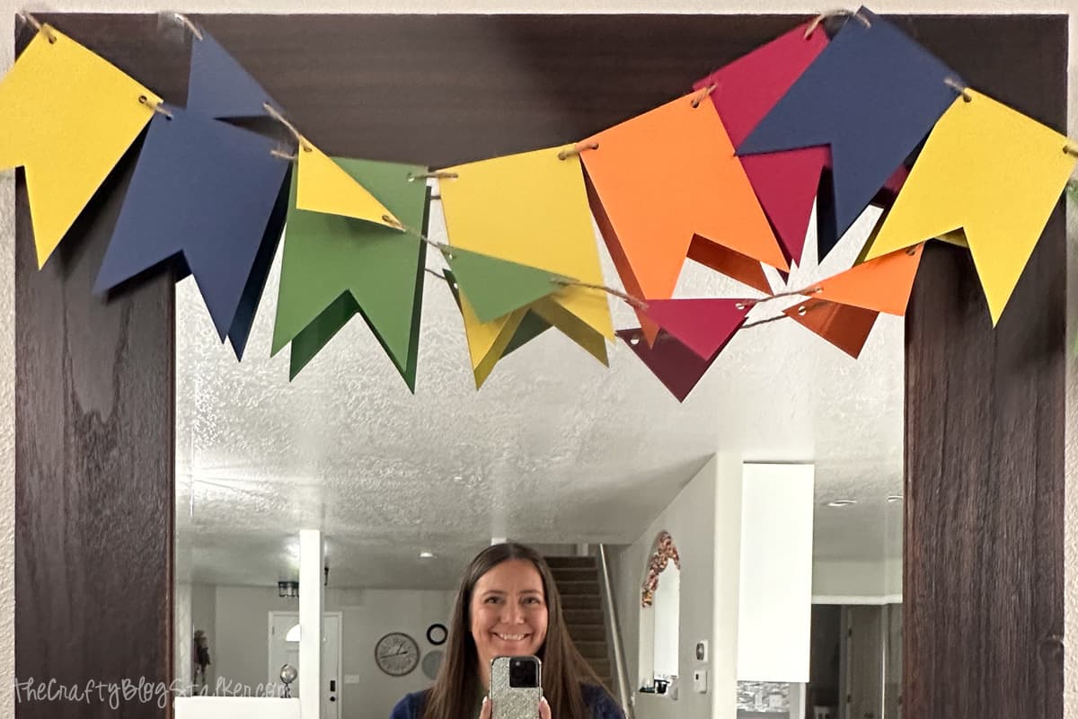 Two handmade paper banners hung over a mirror.