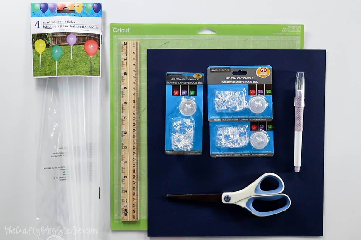 Supplies Used: cardstock, balloon sticks, LED candles, scissors, ruler, and a cricut cutting machine.