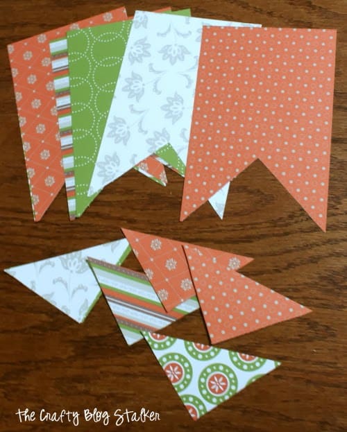 DIY simple pattern paper pennant banners. Customize for any season, them or occasion. This party decor is fun to make and looks great hanging!