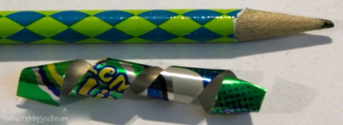 A strip of a soda can wrapped around a pencil to give it a twirly shape.
