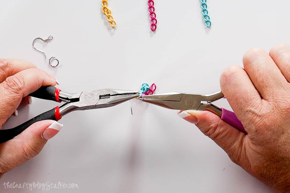 opening chain link with two pairs of jewelry pliers