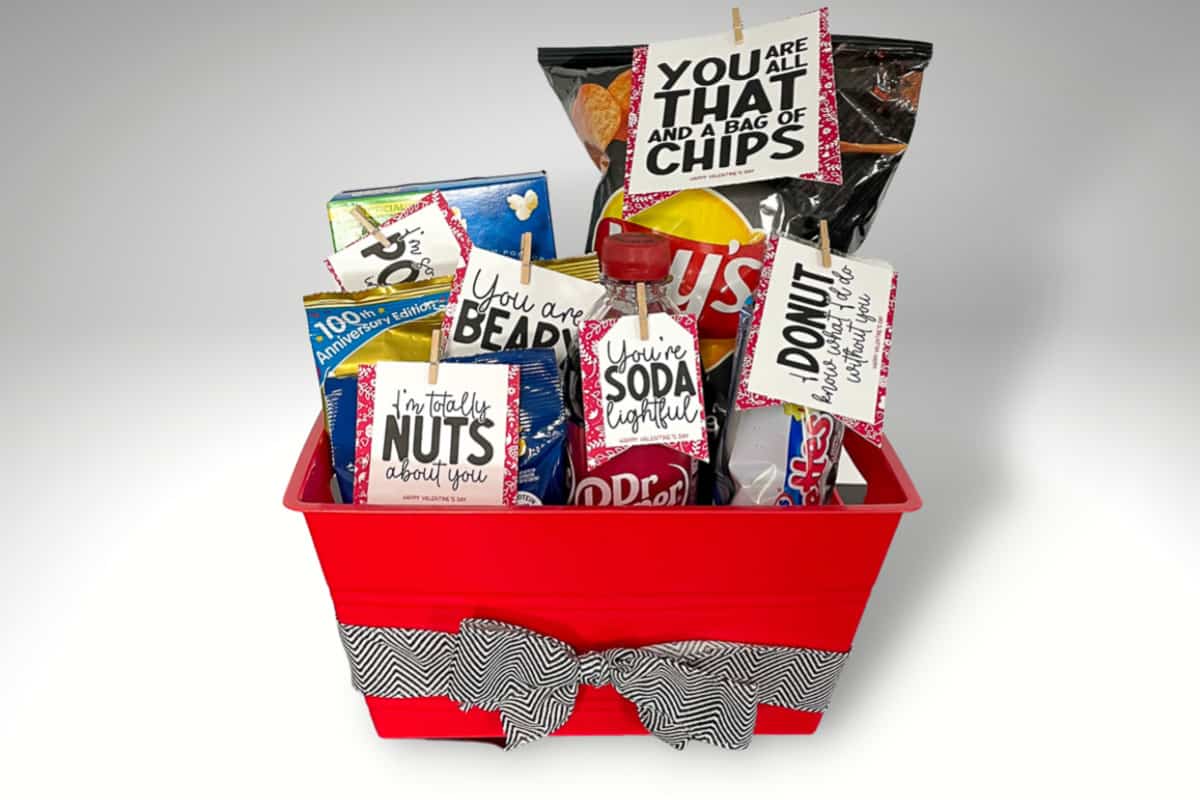 Plastic basket filled with treats and printable valentine tags.