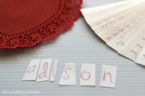 rub-on letters cut out to apply to the paper heart doily