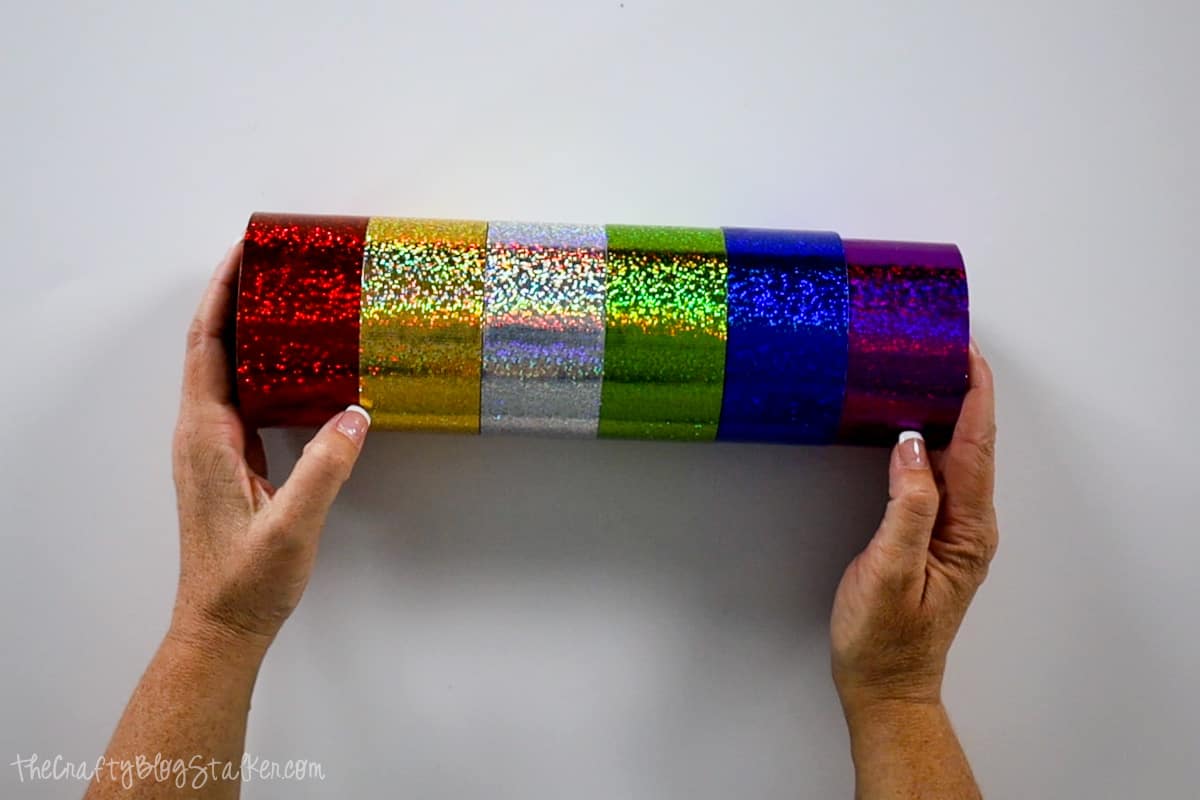 A stack of 6 holographic duct tapes in red, gold, silver, green, blue and purple