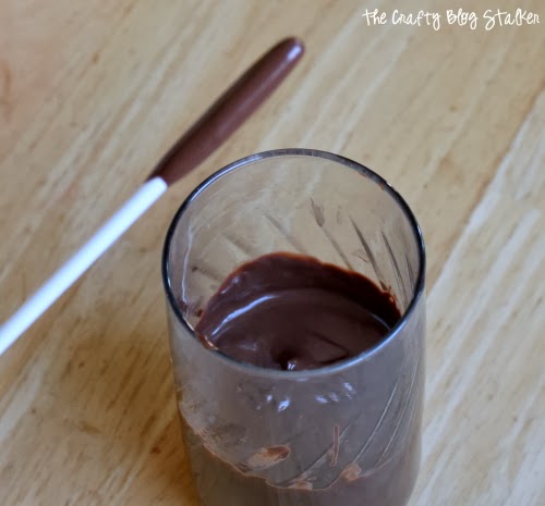 dipping the tip of the stick in chocolate