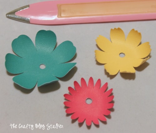 shaping the paper flowers with a bone-folder