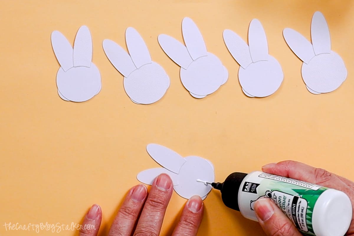 Adding a strip of glue to the back of the bunny face.
