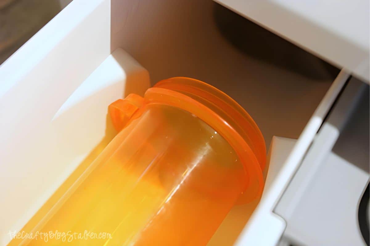 Prescription bottle in a the soap drawer of a washing machine.