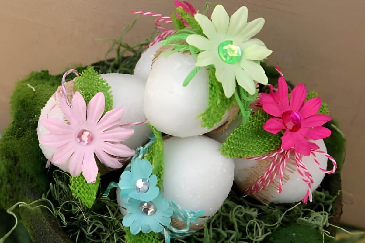 Several decorated glitter eggs in a planter.