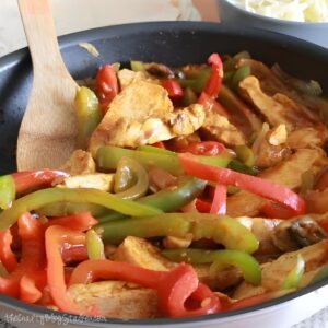 Chicken fajitas in a pan.