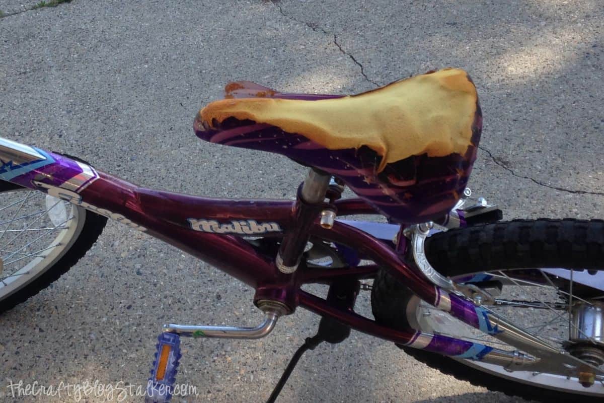 A torn bicycle seat showing the foam padding inside.