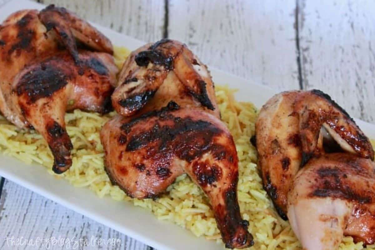 Plated cornish hens on a bed of rice.