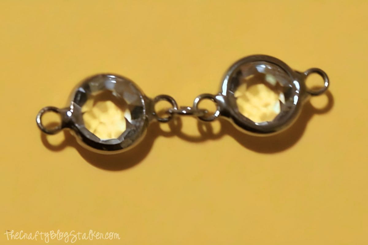 Two crystal charms joined together with a jump ring.