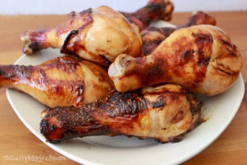 grilled chicken drumsticks on a white plate