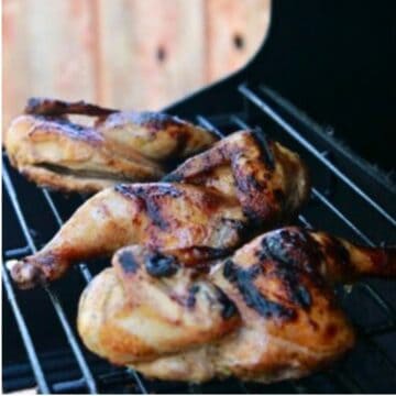 Cornish Hens grilling on a BBQ.
