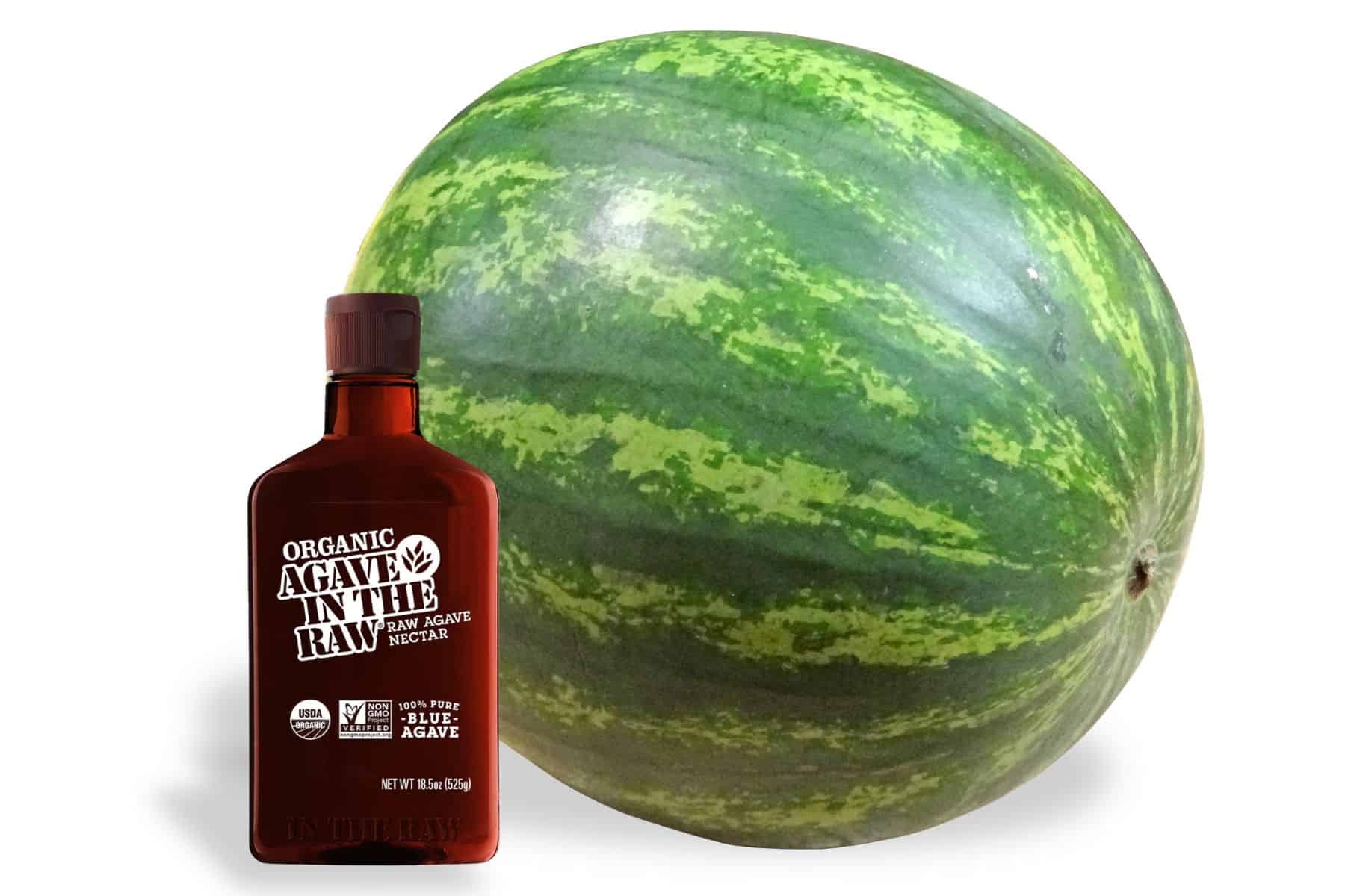 Whole watermelon and bottle of organic agave nectar displayed side by side, showing the two main ingredients for watermelon agave snowballs.