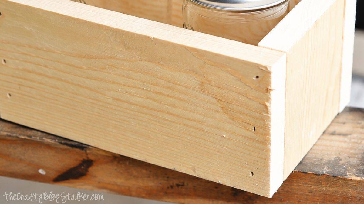 Make your very own Chalkboard Candle Box complete with DIY Citronella Candles Close-up of an unfinished wooden box with nailed corners, showing the assembled frame for a DIY citronella candle box project.