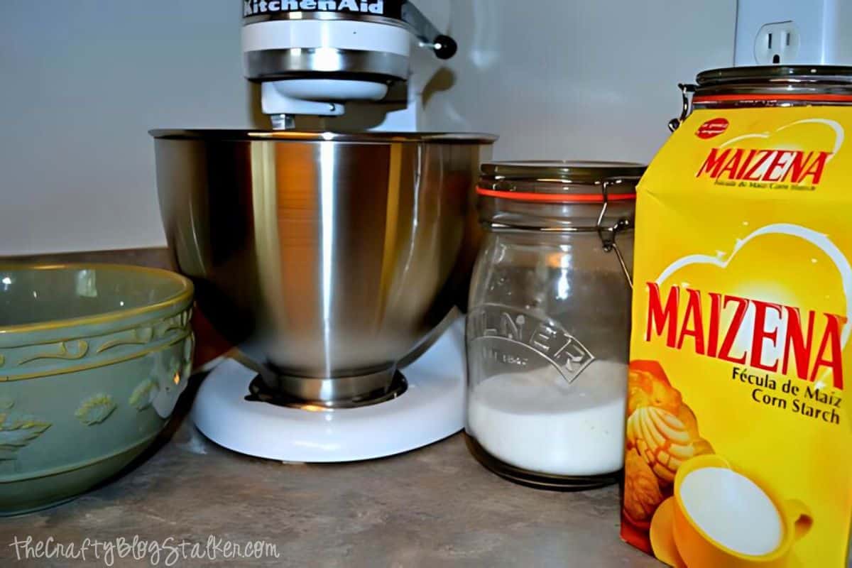 Supplies to make cookies -  mixer, sugar, and a bowl.