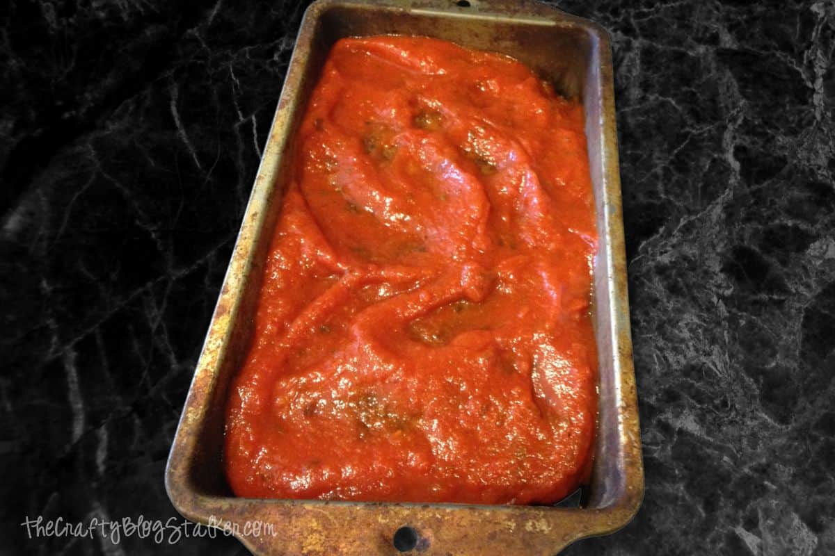 Meatloaf covered with pasta sauce.