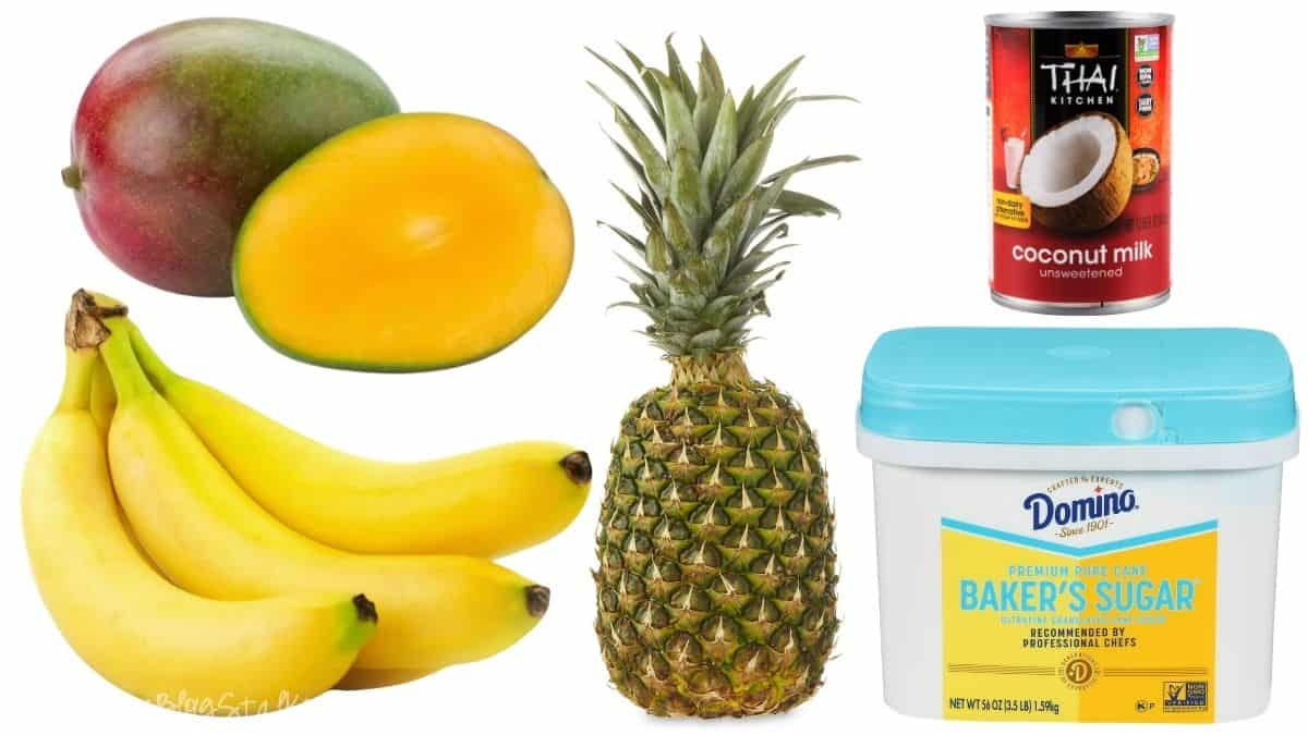Mango, sliced mango, bananas, a whole pineapple, a can of coconut milk, and a container of sugar arranged as popsicle ingredients.