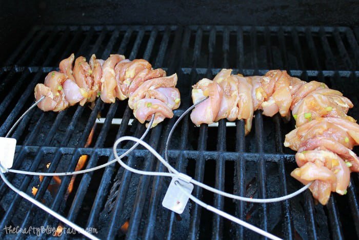 chicken on the grill threaded with a fire wire