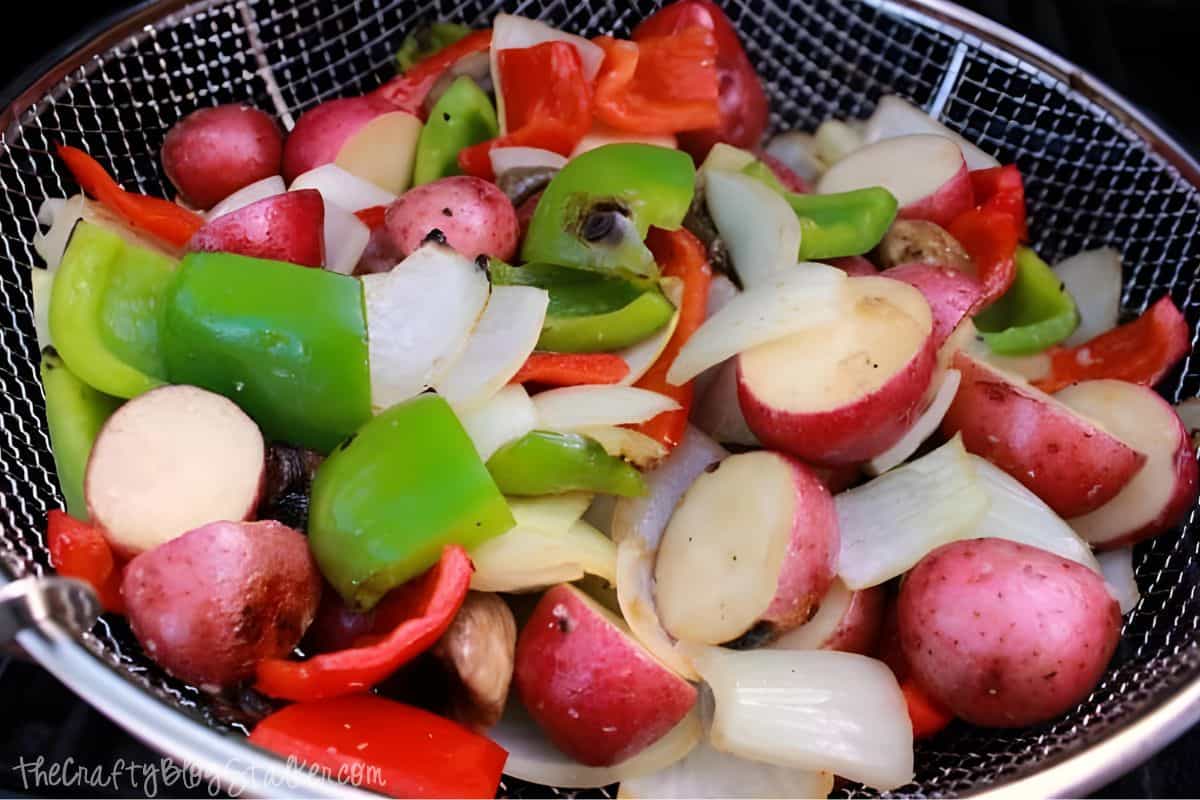 Vegetables that are done grilling in the skillet.