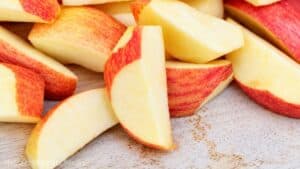 Slices of fresh red and yellow apples for homemade applesauce.
