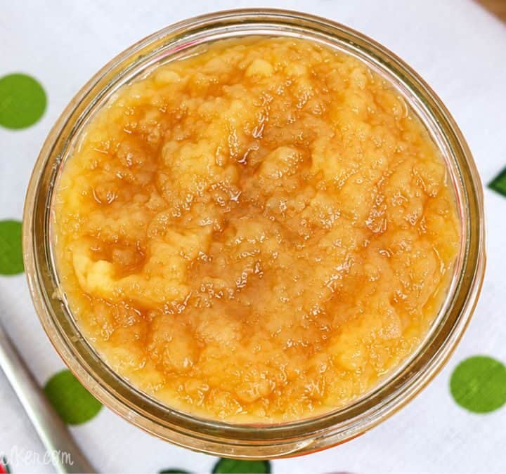 Close-up of homemade unsweetened applesauce in a glass jar.