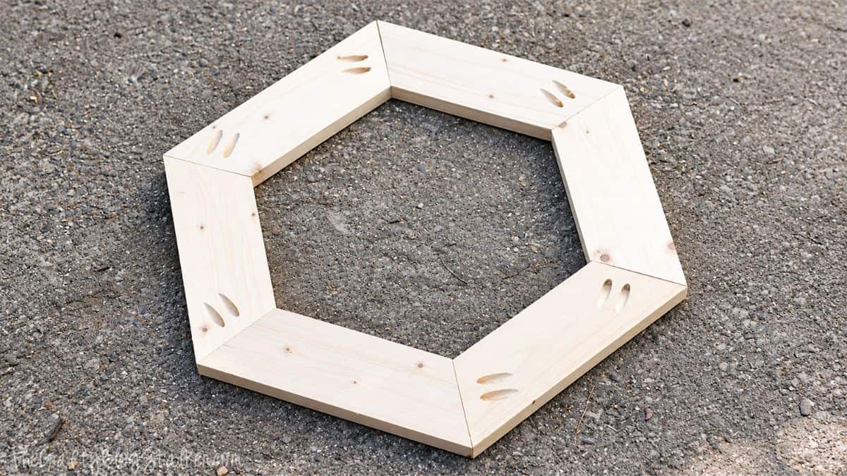Hexagon Wooden Fall Wreath Tutorial | The perfect rustic accent to this years fall decor! Wooden hexagon wreath base for fall craft projects on concrete surface.