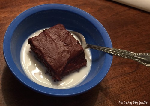 a piece of chocolate cake in a bowl of milk